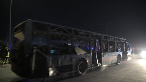 Security forces remove a damaged bus after Tuesday's blasts near the Afghan parliament in Kabul.