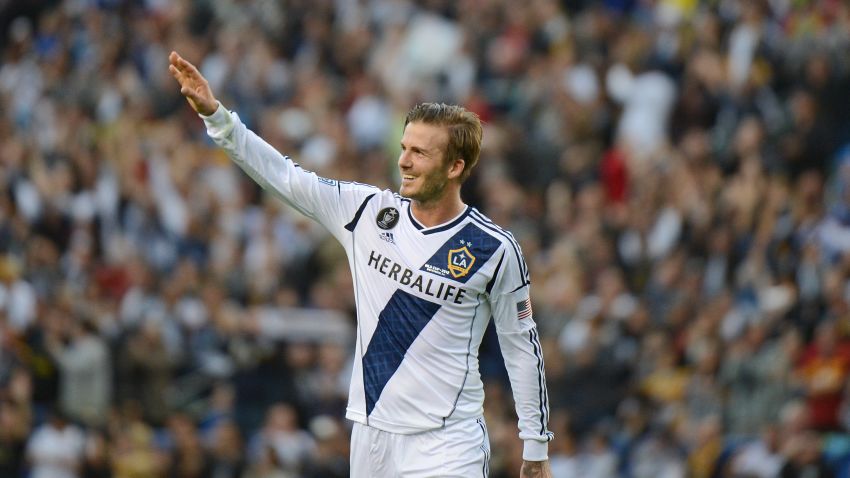David Beckham waves to fans as he walks off the pitch after the Los Angeles Galaxy defeat the Huston Dynamo in the Major League Soccer (MLS) Cup, December 1, 2012 in Carson, California. It was Beckham's last game with the Galaxy. AFP PHOTO / Robyn Beck        (Photo credit should read ROBYN BECK/AFP/Getty Images)