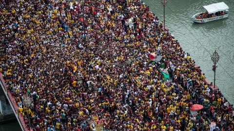 Devotees fight through huge crowds to touch a centuries-old icon on Monday, January 9.