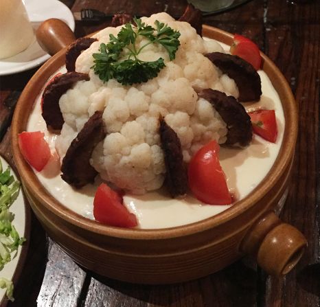 <strong>Cauliflower Surprise --</strong> This, says Pallai, is "a whole cauliflower on a bed of white sauce, but sectioned into it are [frozen food brand] Bird's Eye beef burgers." Definitely surprising. 