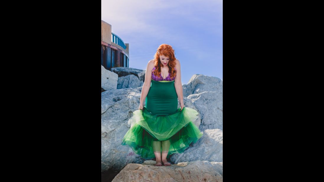 The Little Mermaid wanted to walk on land and felt like an outcast in the sea. May was bullied and teased as the outcast as a child. She's shown standing confidently on her own two feet.