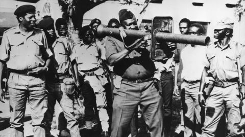 Idi Amin firing a rocket launcher with troops still loyal to him in April 1979.
