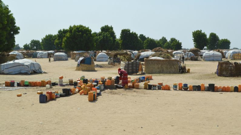 Families have to line up their cans near a bore hole for their daily water collection.
