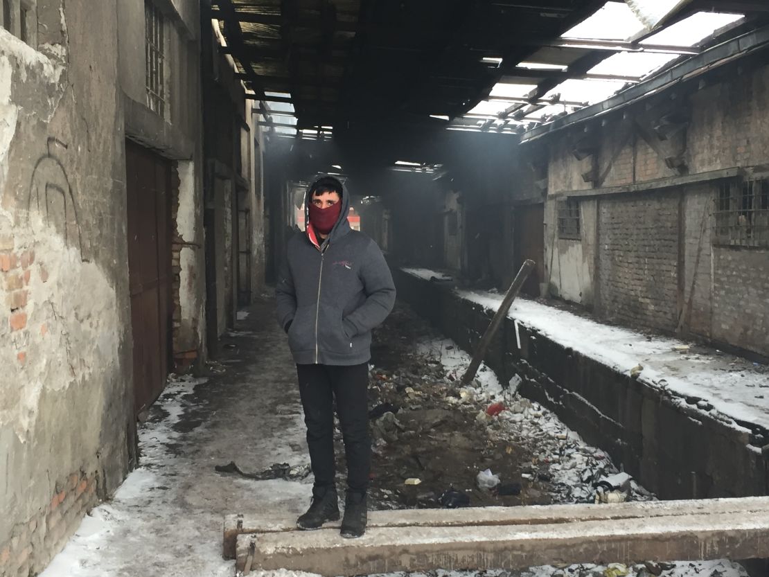 Migrants use this icy thin plank to get from one hall to the back of the building where they have a minimum of privacy to go to the toilet.