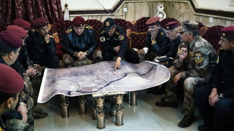 Staff General Taleb Shegati al-Kenani (C), top commander of the Counter-Terrorism Service, studies a map with his team of officers in Mosul's Al-Zahraa neighbourhood on January 7, 2017.