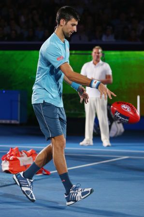 The tennis ace tries out his ball-handling skills.