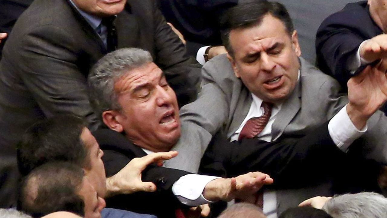Ruling Justice and Development Party and main opposition Republican People's Party lawmakers scuffle at the parliament in Ankara during deliberations over a controversial 18-article bill to change the constitution to create an executive presidency January 11, 2017.
Turkish lawmakers on Thursday approved three more articles in a hugely controversial bill bolstering the powers of President Recep Tayyip Erdogan, as lawmakers brawled and threw objects in a session of high tension. A brawl erupted in the chamber as the voting took place in an overnight session, with lawmakers punching each another and chairs being thrown, television pictures showed.  / AFP / -        (Photo credit should read -/AFP/Getty Images)
