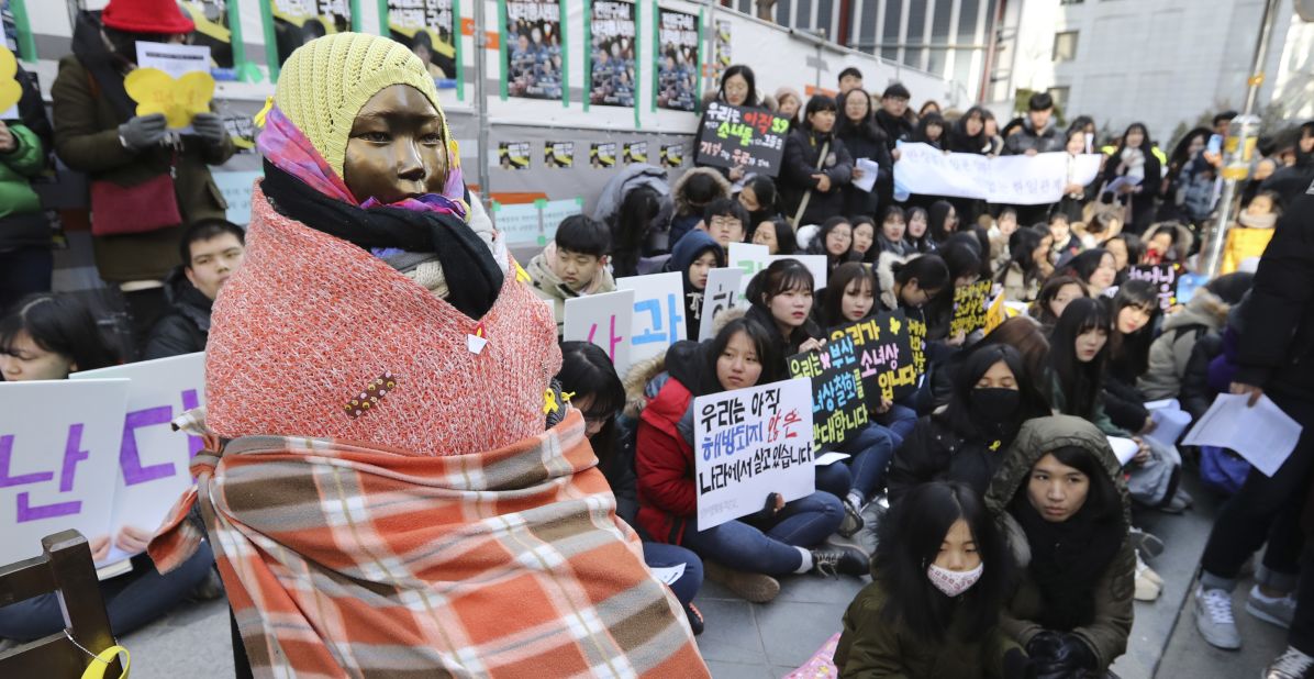 Students gather near a "comfort woman" statue during a rally in front of the Japanese Embassy in Seoul, South Korea for a weekly "Wednesday demonstration" on January 11, 2017.