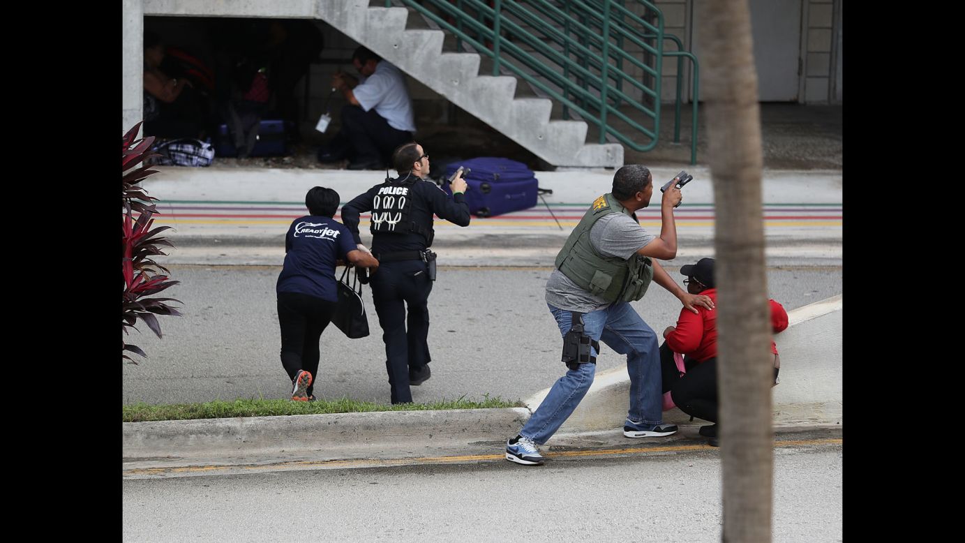 Police help people seeking cover after a shooting at the airport in Fort Lauderdale, Florida, on Friday, January 6. Five people were killed and eight others were wounded when <a href="http://www.cnn.com/2017/01/06/us/fort-lauderdale-airport-incident/index.html" target="_blank">a gunman opened fire</a> in the baggage claim area, officials said.