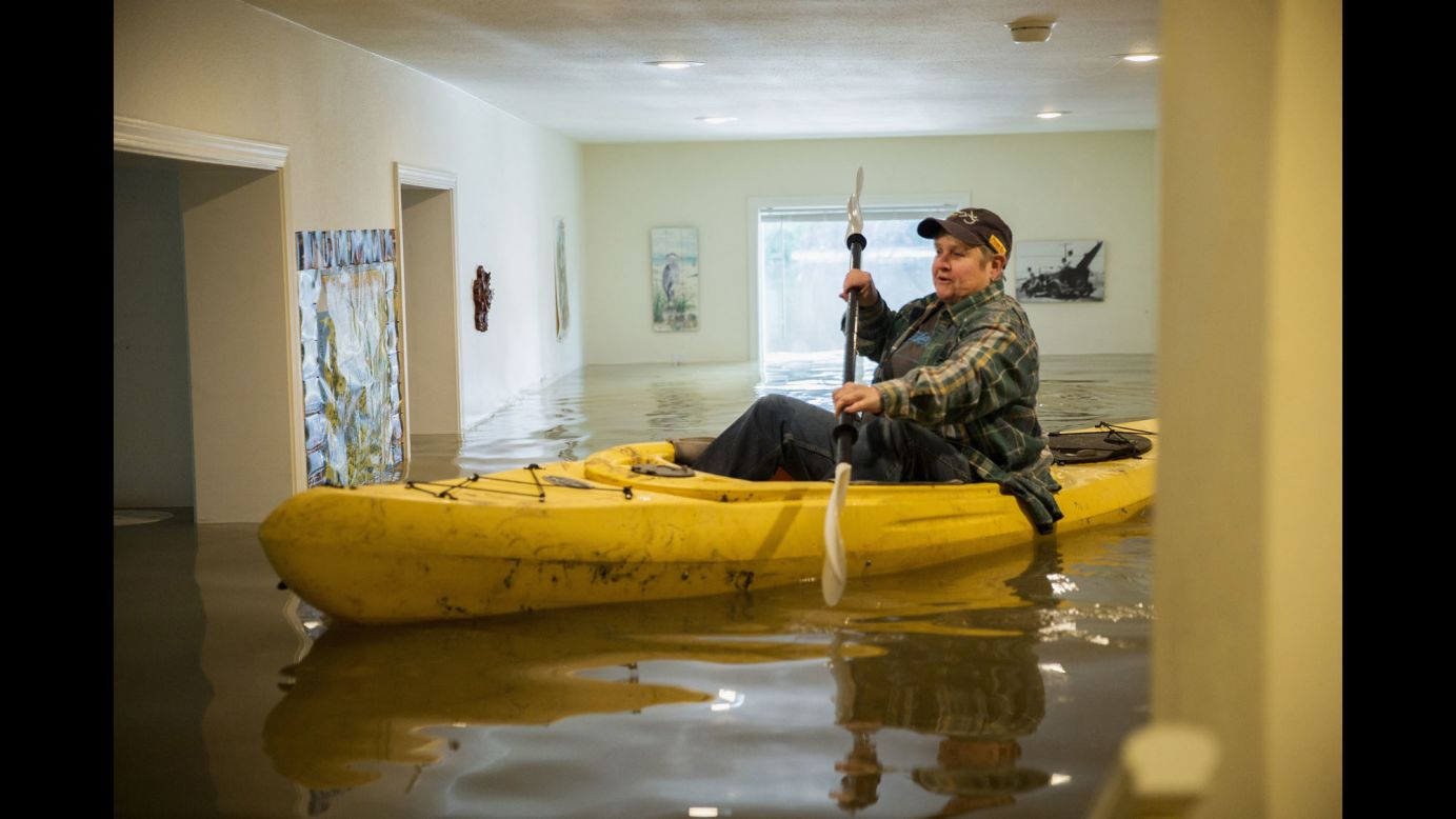 Lorin Doeleman uses a kayak to check her flooded home in Guerneville, California, on Wednesday, January 11. California and Nevada have been dealing with <a href="http://www.cnn.com/2017/01/09/us/us-weather/" target="_blank">flooding, mudslides and heavy snow</a> this week. 