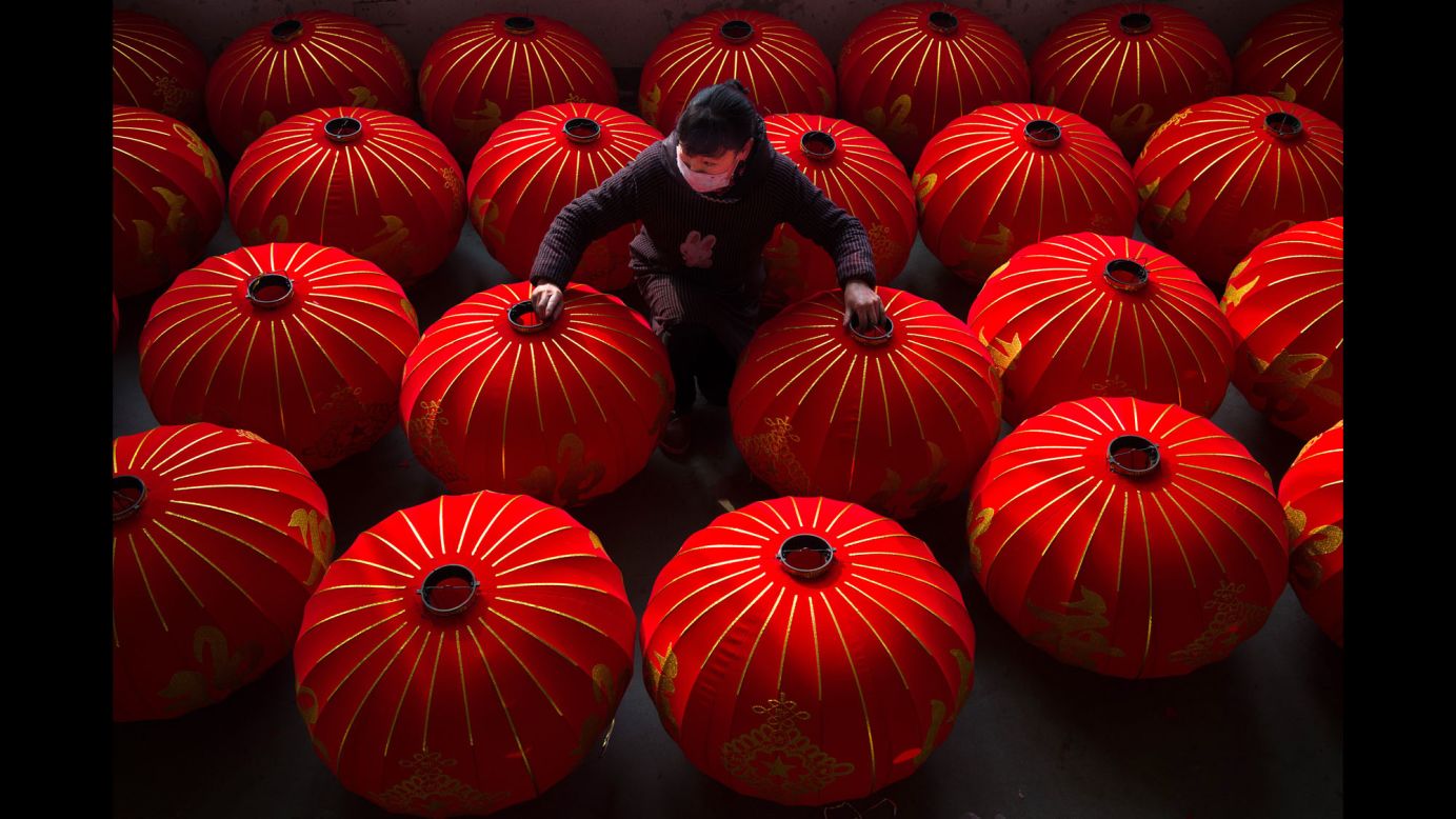 A worker organizes semi-finished lanterns at the Kaiming Lantern Factory in Hefei, China, on Wednesday, January 11. 