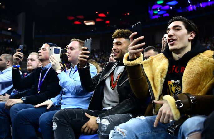 Arsenal footballers Hector Bellerin (right) and Alex Oxlade-Chamberlain snap shots of Thursday's NBA clash between the Nuggets and the Pacers at London's O2 Arena.