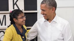 US President Barack Obama smiles with a 16-year-old refugee girl from Myanmar that was subjected to human trafficking and will now be moving to the United States, following a tour of the Dignity for Children Foundation in Kuala Lumpur on November 21, 2015 on the sidelines of his participation in the Association of Southeast Asian Nations (ASEAN) Summit. The Foundation serves more than 1,000 poor and vulnerable children, many of them refugees, in a specialized learning environment to help develop children academically and socially to empower them to become productive members of society.  Obama and his counterparts from China, India, Japan and elsewhere are meeting in Kuala Lumpur for two days of talks hosted by the 10-country ASEAN.   AFP PHOTO / SAUL LOEB        (Photo credit should read SAUL LOEB/AFP/Getty Images)