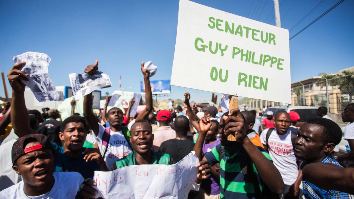 Supporters of Guy Philippe protest in front of the US Embassy on Friday in Port-au-Prince.       