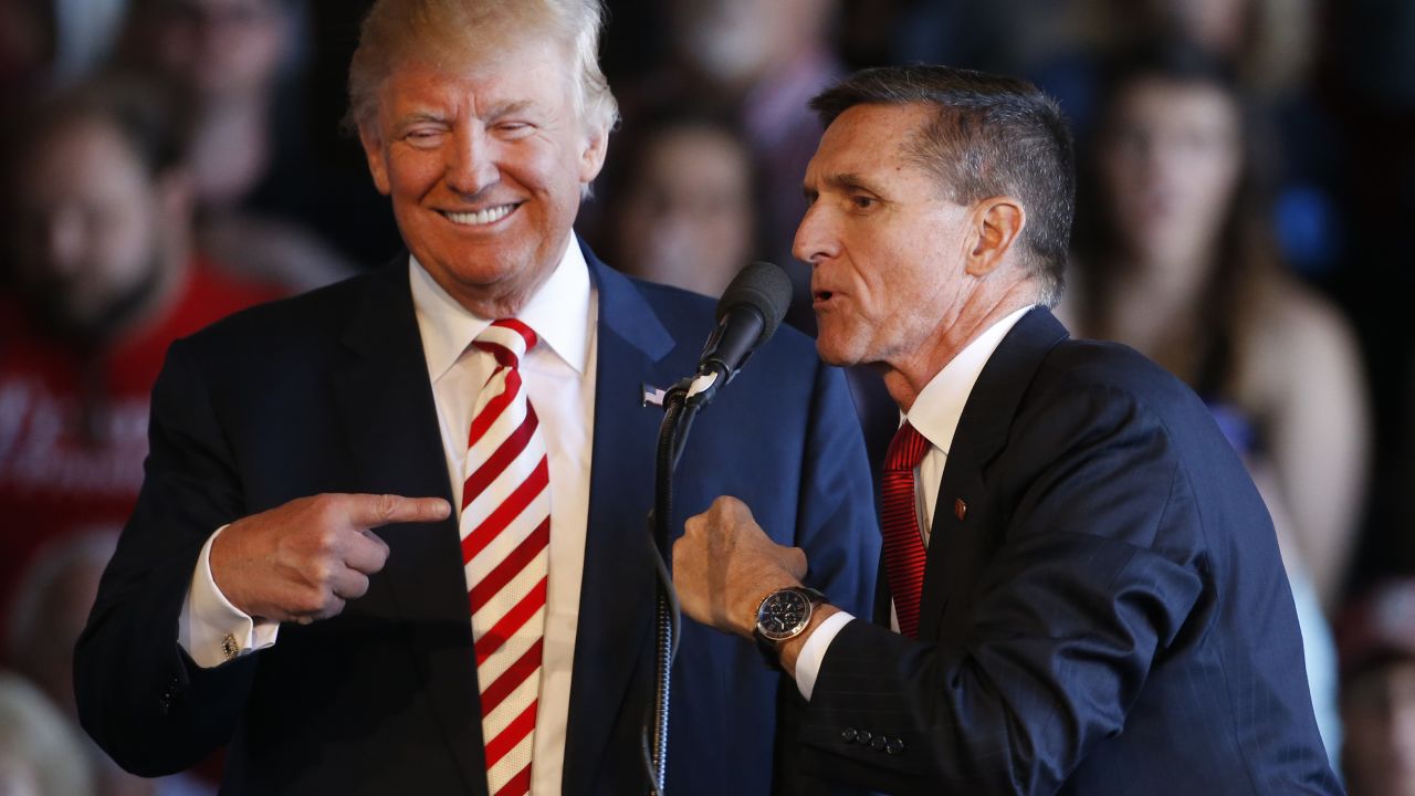 Donald Trump jokes with retired Gen. Michael Flynn as they speak at a rally at Grand Junction Regional Airport on October 18, 2016.