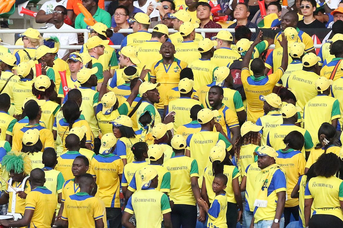 Gabon supporters dressed in national colors cheer for their team.