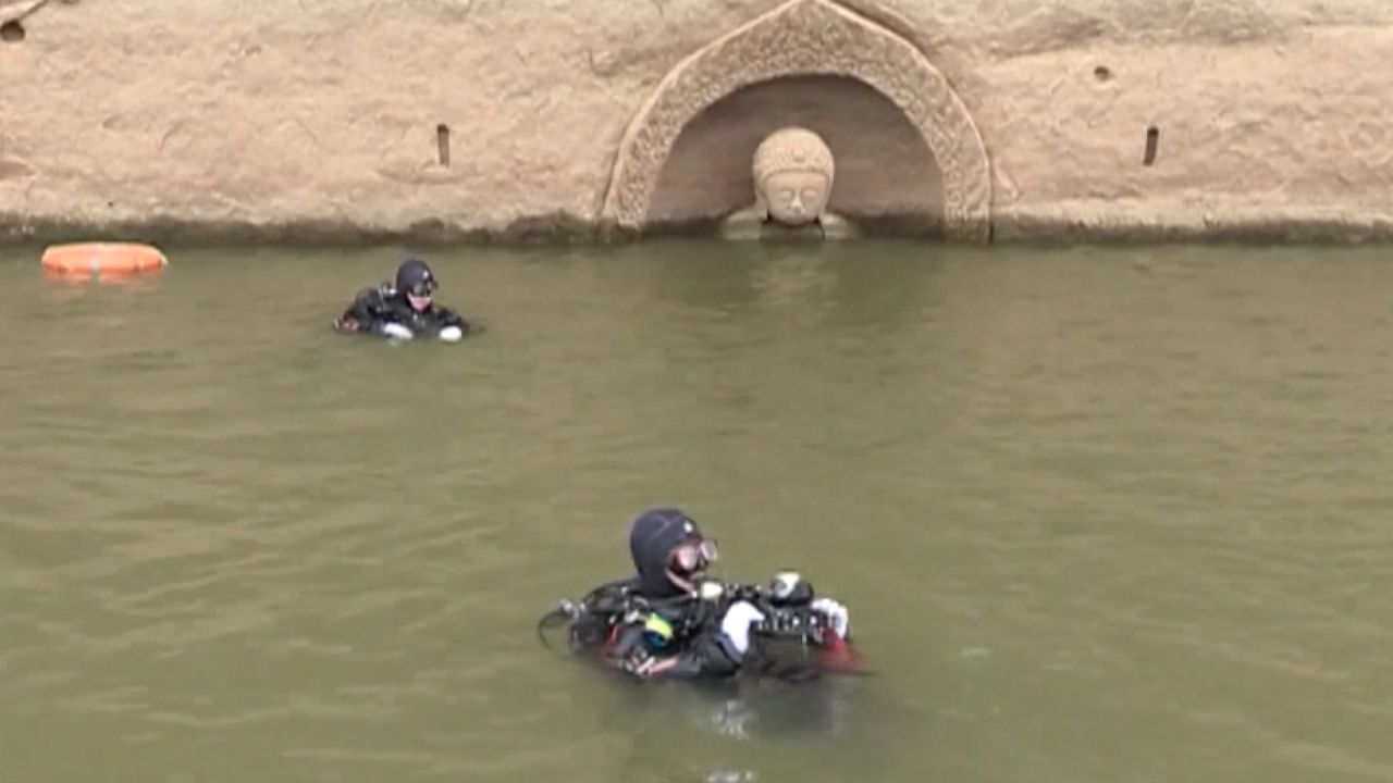 An underwater archeology team is investigating both the ancient town and the statue. 