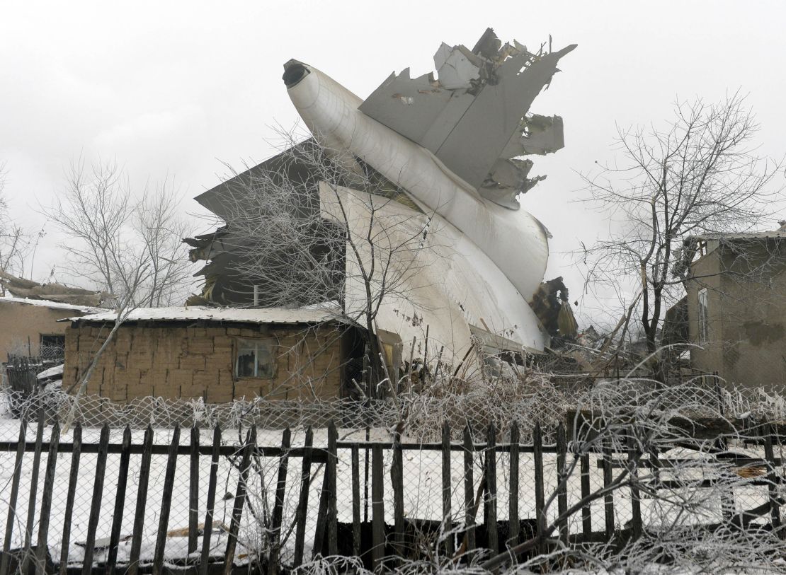 The tail of a crashed  Boeing 747 cargo plane lies in a residential area outside Bishkek, Kyrgyzstan.