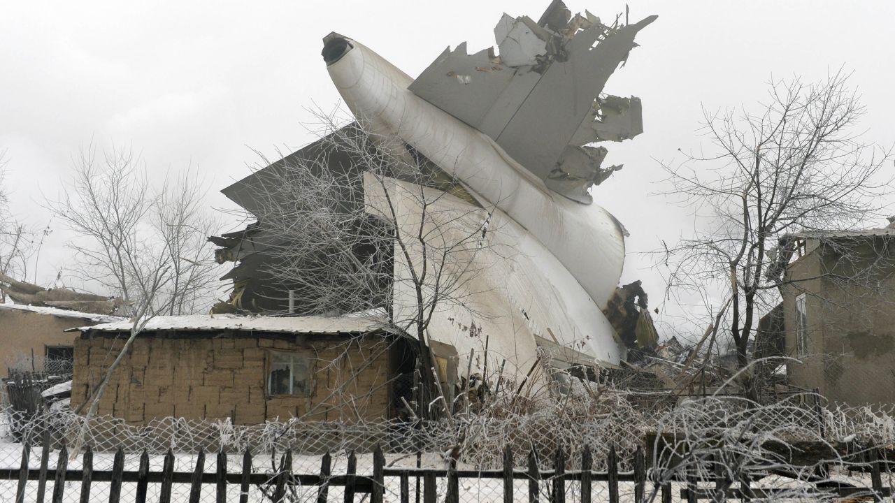 The tail of a crashed  Boeing 747 cargo plane lies in a residential area outside Bishkek, Kyrgyzstan.