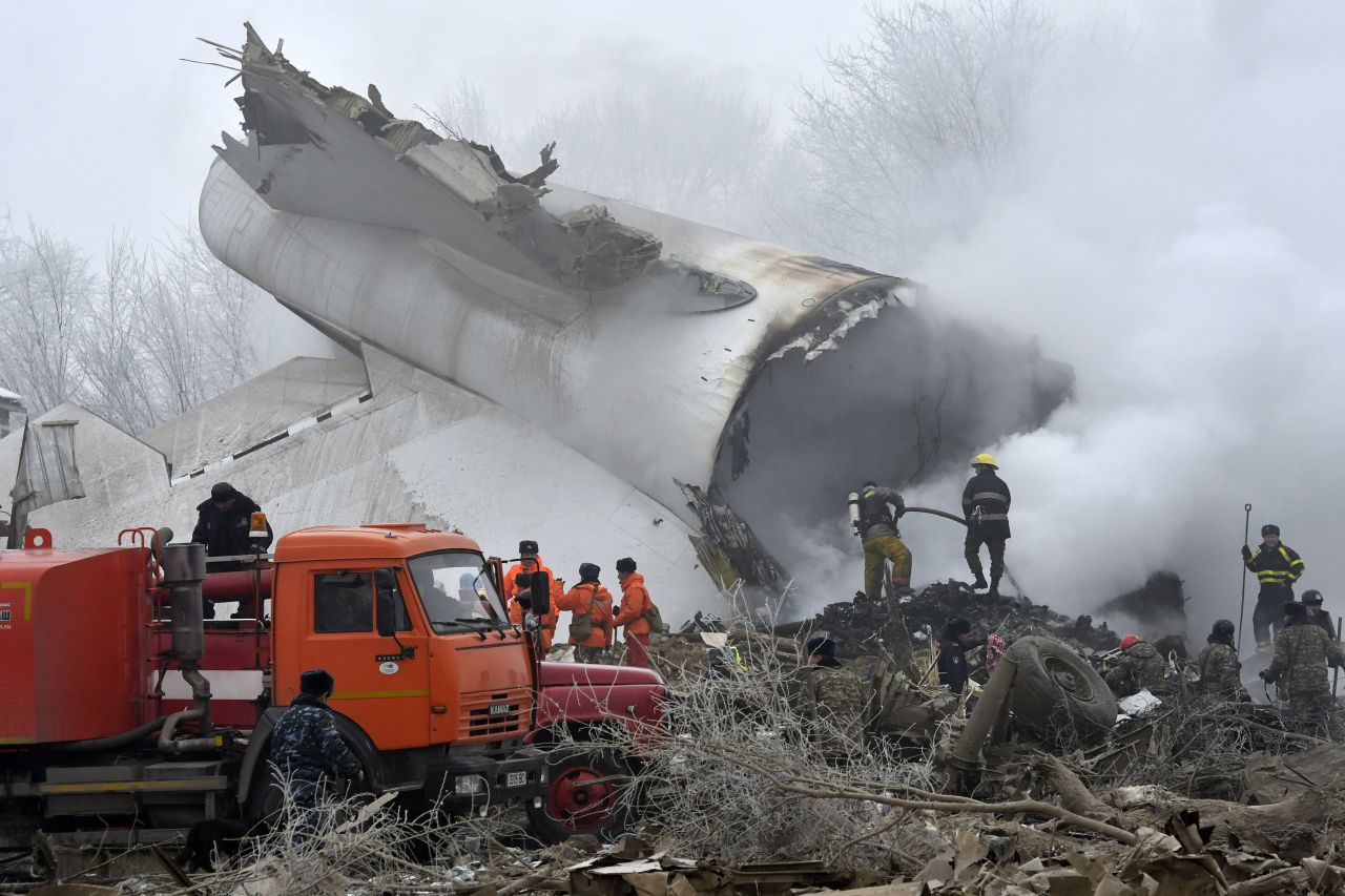 Emergency responders work amid the debris of a Turkish Boeing 747 cargo plane that crashed into a village outside Bishkek, Kyrgyzstan, on Monday, January 16. Dozens were killed in the crash, including people on the plane and residents of the area adjacent to Manas airport where the plane crashed.