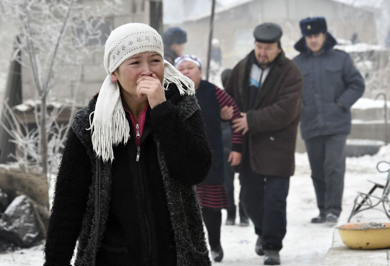 Relatives of victims react as Kyrgyz emergency officials search through the debris of the crash. At least eight people were hospitalized, Kyrgyzstan's state-run Kabar Agency reported.