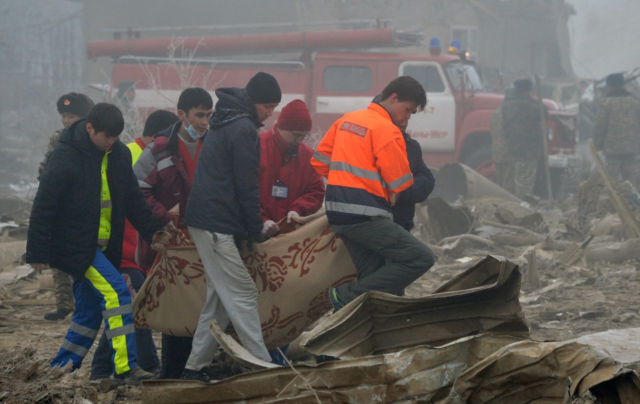 Emergency personnel recover the body of a crash victim.
