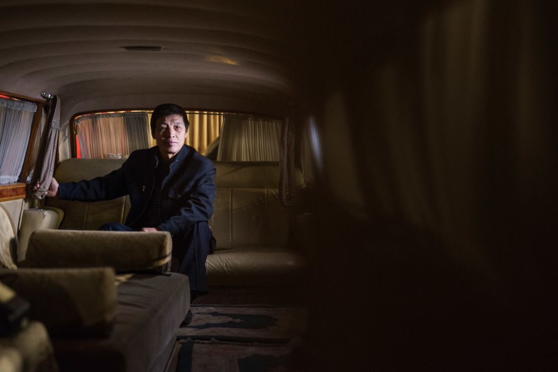 Luo Wenyou poses inside a stretch limo manufactured by Hongqi. It was intended for Mao Zedong.