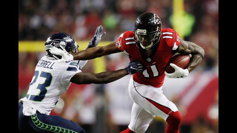 Atlanta Falcons wide receiver Julio Jones, right, stiff-arms Seattle Seahawks safety Steven Terrell during the NFC divisional playoff game on Saturday, January 14, in Atlanta. The Falcons defeated the Seahawks 36-20 and will advance to the NFC Championship against the Green Bay Packers.