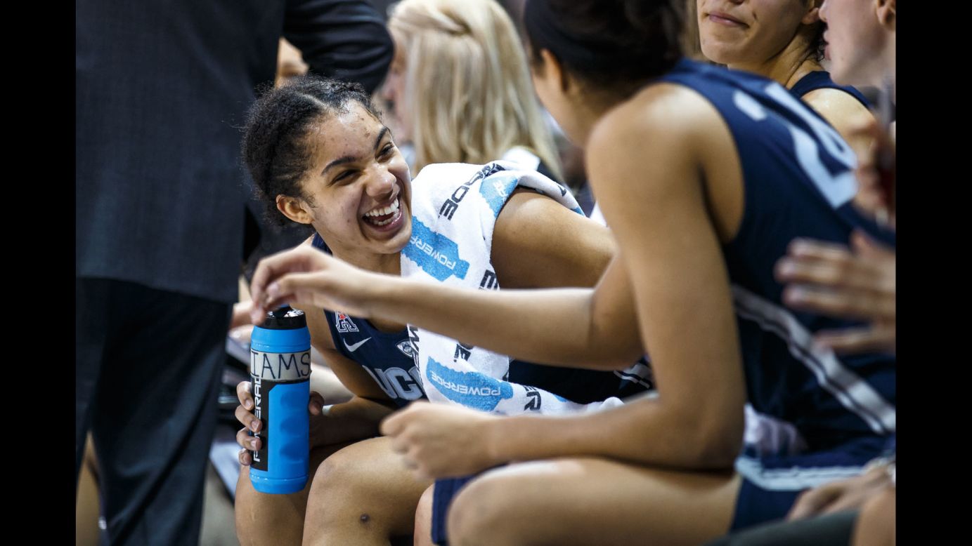 UConn Huskies forward Gabby Williams laughs with teammates during the American Athletic Conference college basketball game against the SMU Mustangs on January 14. The Huskies won the game 88-48, setting an NCAA record with their 91st consecutive win.