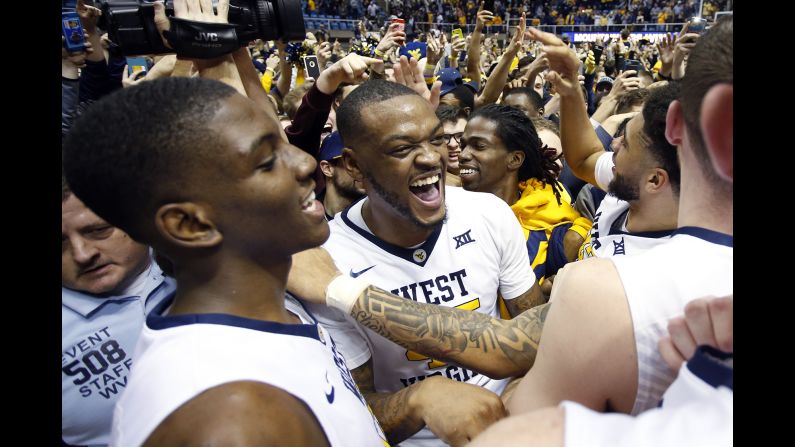 Elijah Macon, center, of the West Virginia Mountaineers celebrates with teammates after upsetting Baylor 89-68 on January 10 in Morgantown, West Virginia. 