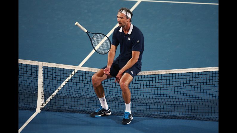 Goran Ivanisevic of Croatia tosses his racquet while sitting on the net during the first day of the 2017 World Tennis Challenge on January 10 in Adelaide, Australia.