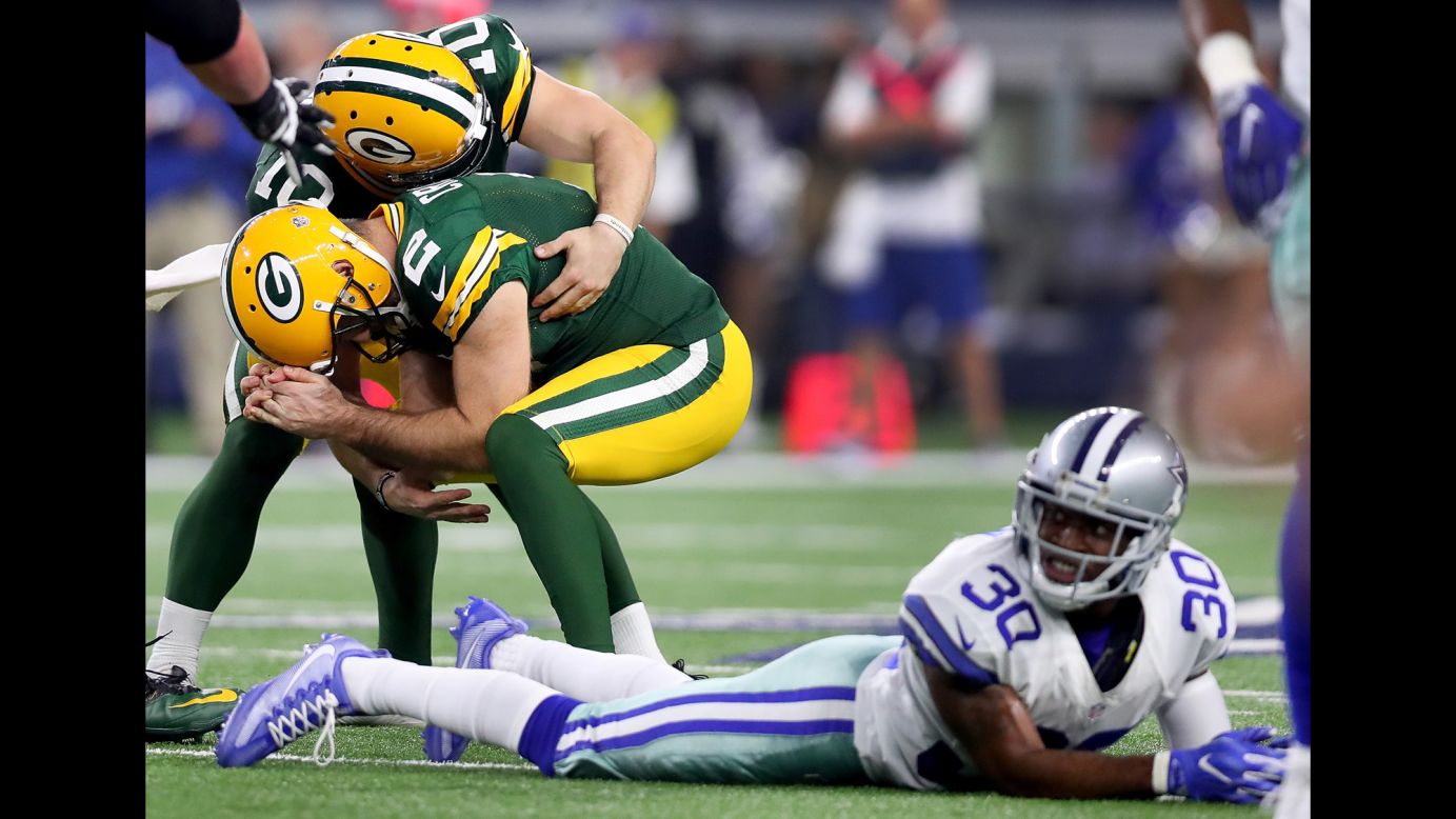 Green Bay Packers kicker Mason Crosby, second left, celebrates with Jacob Schum after scoring the game-winning field goal against the Dallas Cowboys in the final seconds of the NFC Divisional Playoff game on January 15. The Packers beat the Cowboys 34-31.