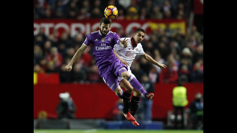 Nacho Fernandez of Real Madrid, left, competes for the ball with Wissam Ben Yedder of Sevilla during the La Liga match at Estadio Ramon Sanchez Pizjuan on January 15, in Seville, Spain. 