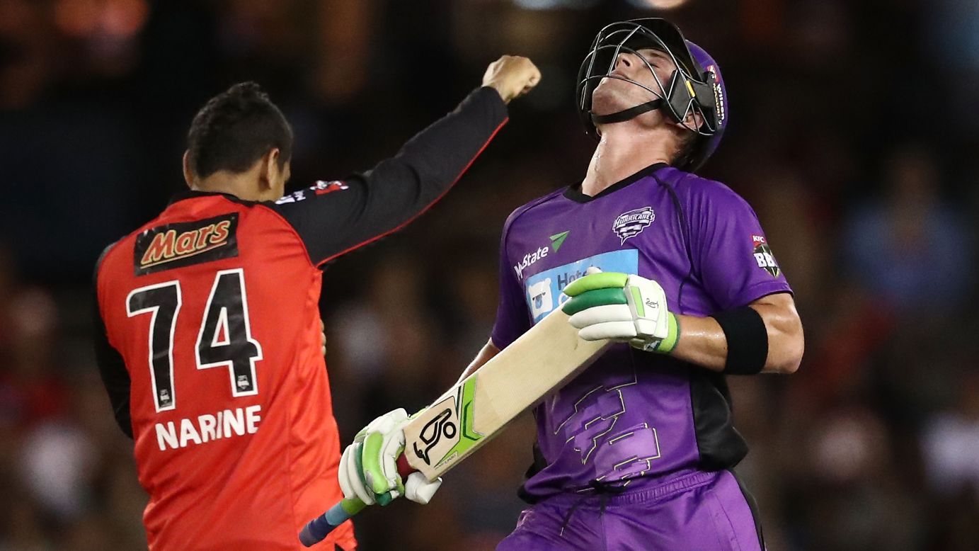 Ben McDermott of the Hobart Hurricanes, right, tilts his head back as he reacts to being dismissed by Sunil Narine of the Melbourne Renegades during the Big Bash League match on January 12, in Melbourne.