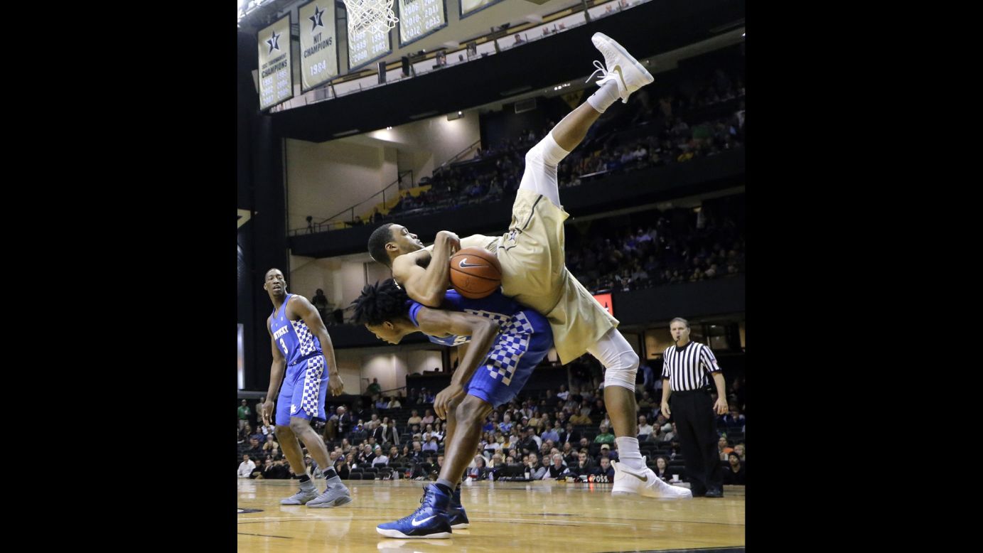 Vanderbilt forward Jeff Roberson, in gold, lands on Kentucky guard De'Aaron Fox during the first half of an NCAA college basketball game on January 10 in Nashville.