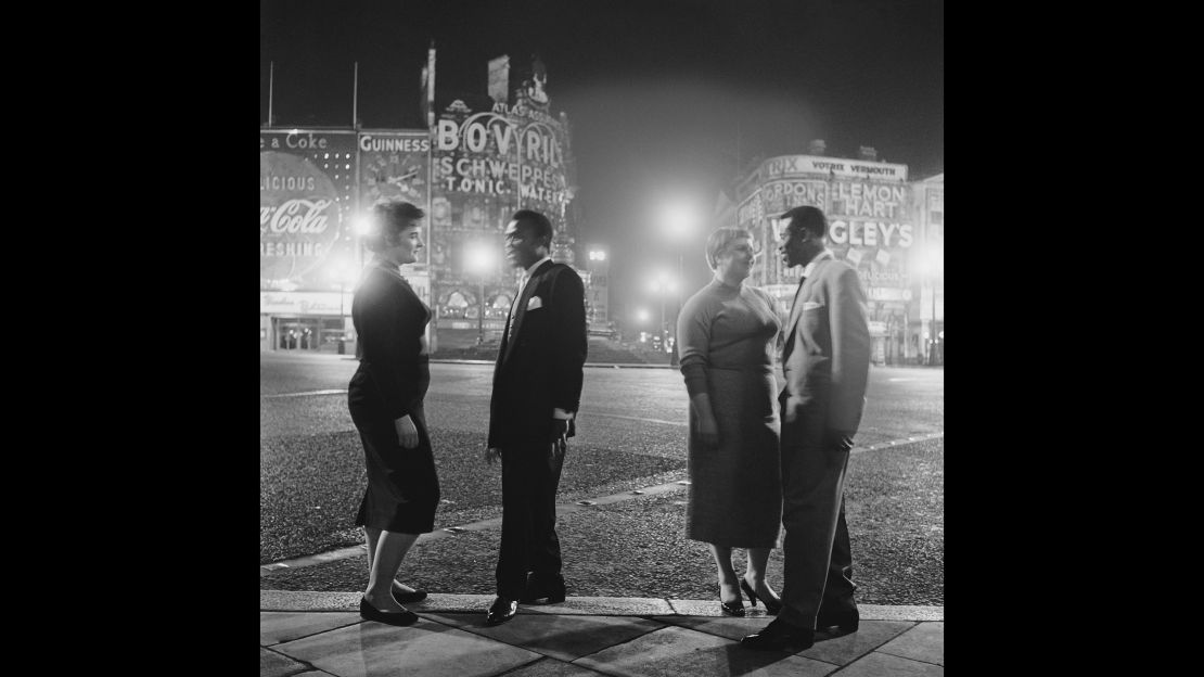 The lights were blacked out during World War II but by the time this picture of American troops and their girlfriends was taken in 1955, the area was vibrantly-lit again.