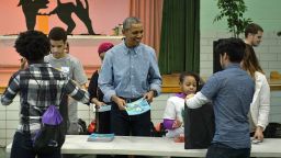 President Barack Obama helps give out books at Leckie Elementary School while celebrating Martin Luther King Day January 18, 2016 in Washington, DC. 