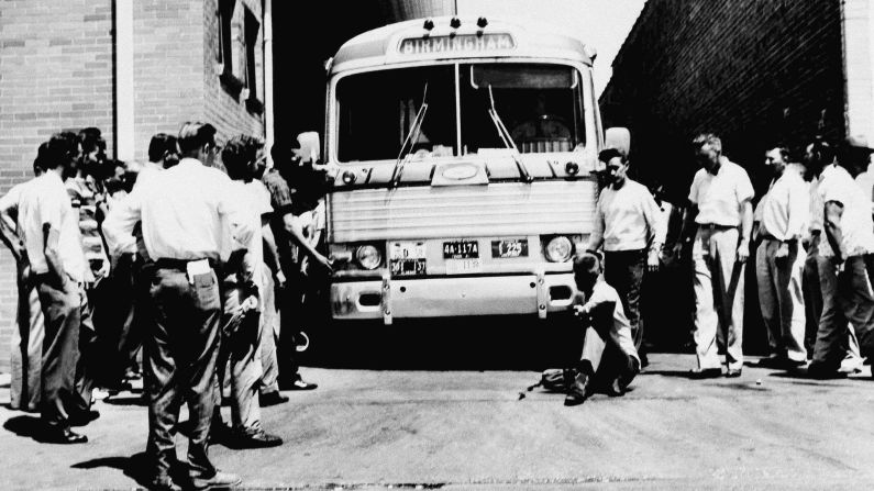 A white man in Anniston, Alabama, sits in front of a bus to prevent it from leaving the station with a load of Freedom Riders on May 15, 1961.