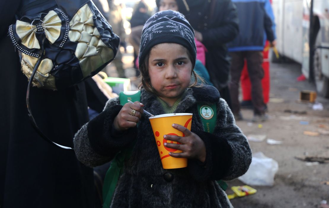 A Syrian girl evacuated from rebel-held eastern Aleppo, eats after arriving in opposition-controlled Khan al-Assal.