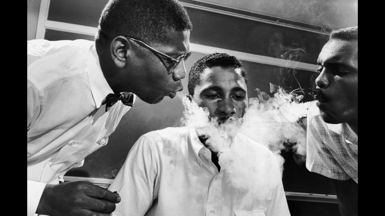 Activists would often undergo tolerance training to prepare themselves for what they might encounter during a sit-in. Here, NAACP student adviser David Gunter, left, and Leroy Hill blow smoke into the face of Virginius Thornton.