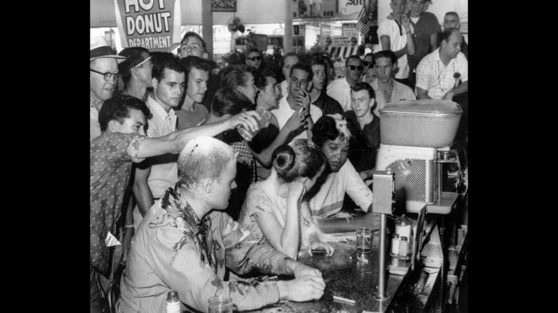 People poured sugar, ketchup and mustard over the heads of Tougaloo College students who were conducting a sit-in at a Woolsworth's in Jackson, Mississippi, in May 1963. Sitting at the counter, from left, are Tougaloo professor John Salter and students Joan Trumpauer and Anne Moody.