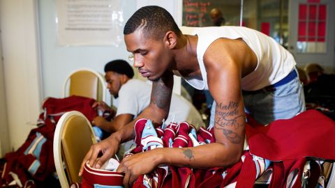 Alex Liddell Jr. helps organize the band's uniforms before rehearsal.