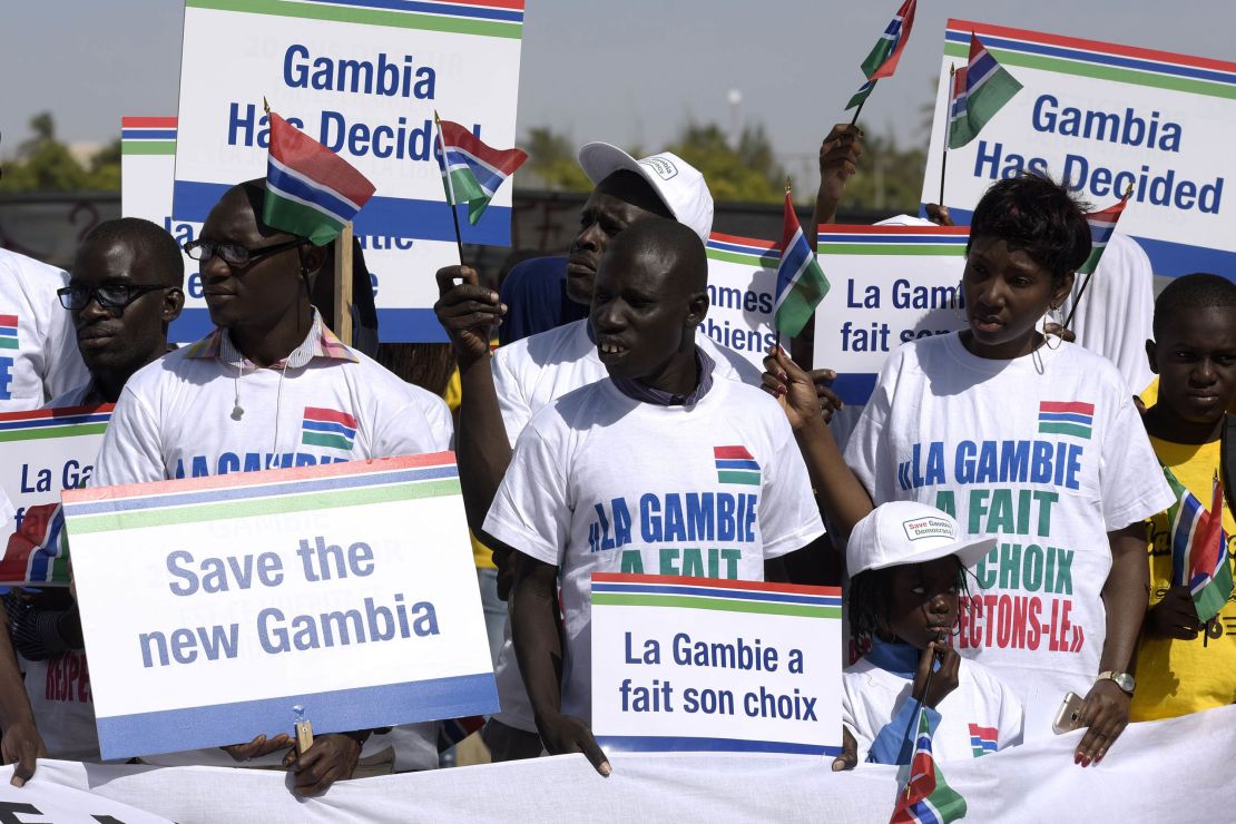 Protesters hold placards supporting Gambia's election results last month in Dakar, Senegal.