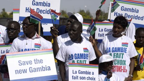 Protesters hold placards supporting Gambia's election results last month in Dakar, Senegal.