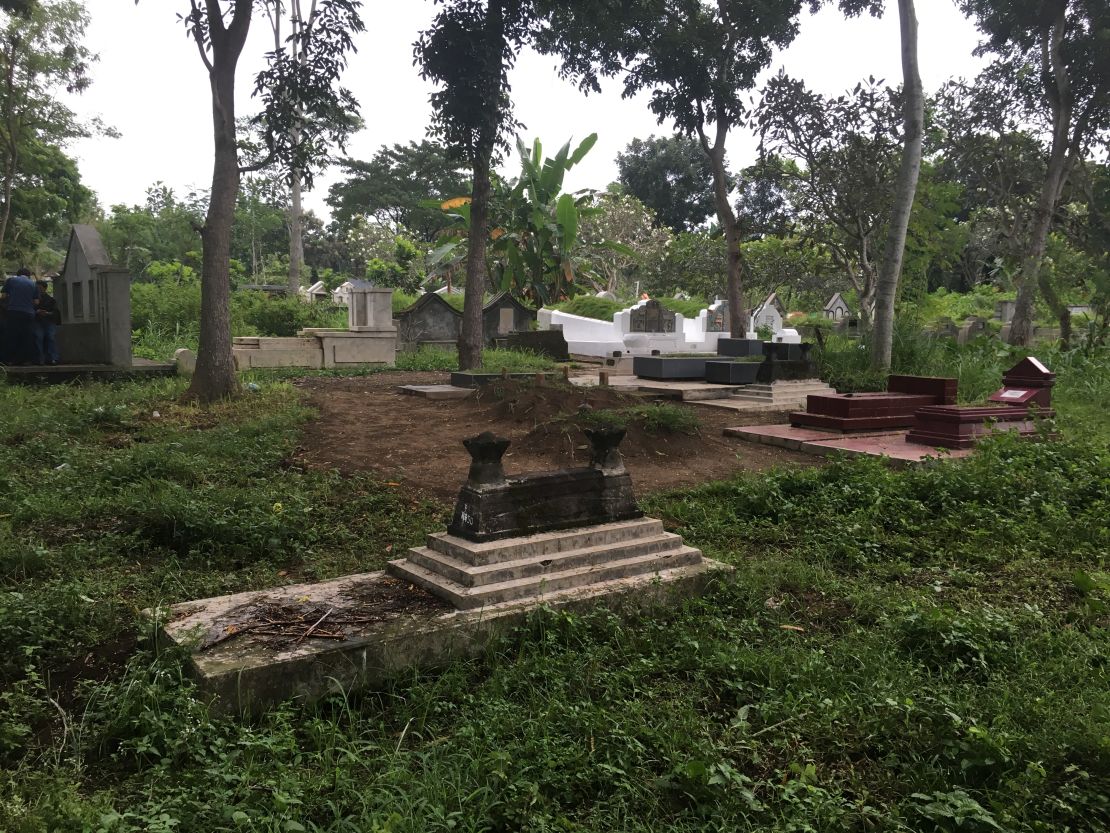 A site of an alleged mass grave, where symbolic tombs mark missing relatives. 