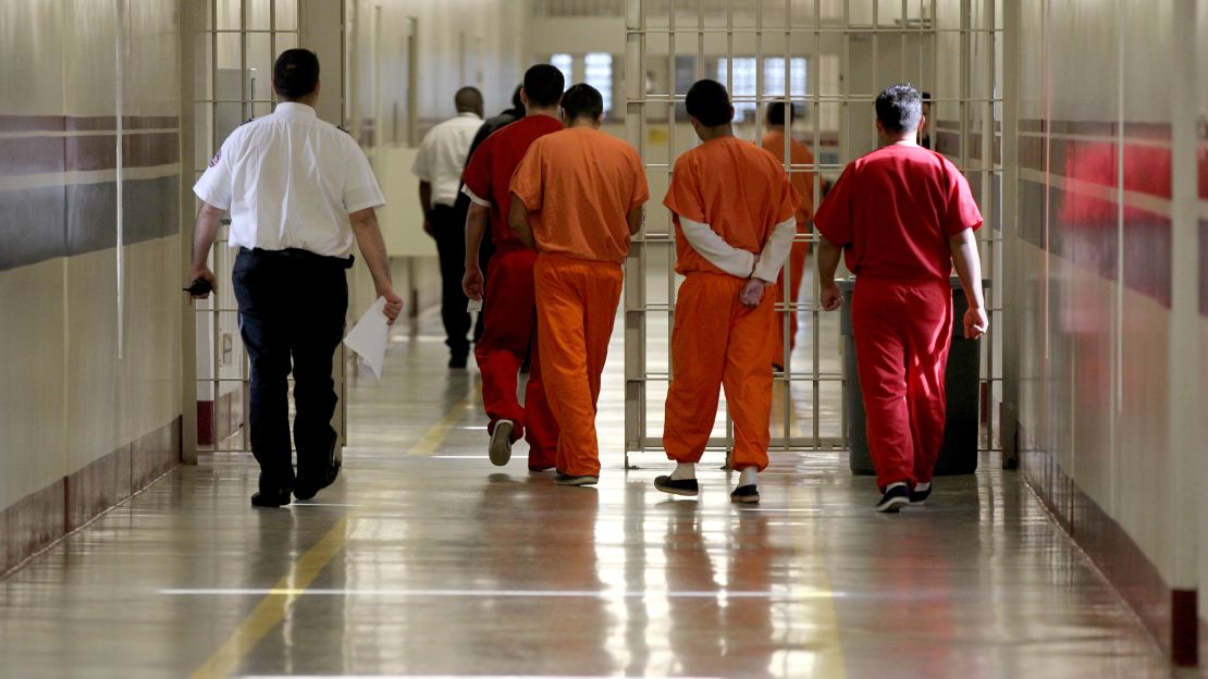 Detainees at the Stewart Detention Center in Lumpkin, Georgia, are escorted through a corridor.