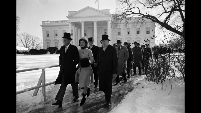 John F. Kennedy, left, walks to his inauguration ceremony alongside his wife, Jackie Kennedy. Kennedy was sworn in as the 35th President of the United States on January 20, 1961.