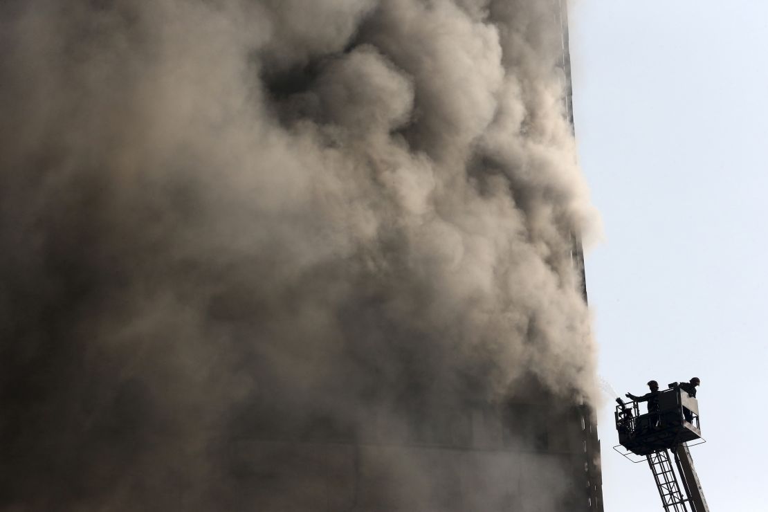 Iranian firefighters work to extinguish the fire at the Plasco building in central Tehran on Thursday.