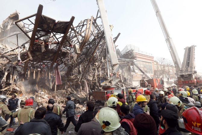 Authorities surround the debris of the collapsed building, which was one of Tehran's oldest high-rises.