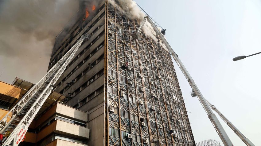 Firefighters battle a blaze that engulfed Iran's oldest high-rise, the 15-storey Plasco building in downtown Tehran on January 19, 2017.State television said 200 firefighters had been called to the scene and 38 had already been injured battling the blaze before it fell. / AFP / STR        (Photo credit should read STR/AFP/Getty Images)